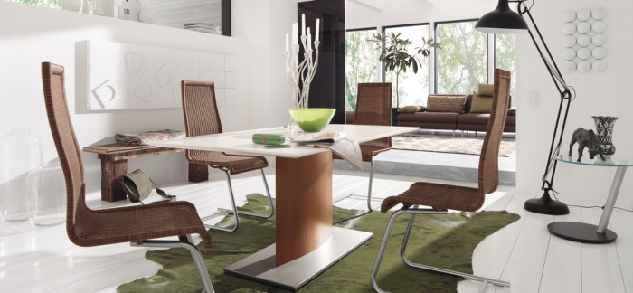 This dining rooms severity is balanced simply by adding the fun green cowhide rug and warm brown of the dining chairs.