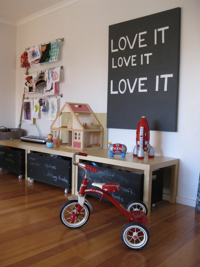 chalkboard storage and red trike child's playroom blonde wood