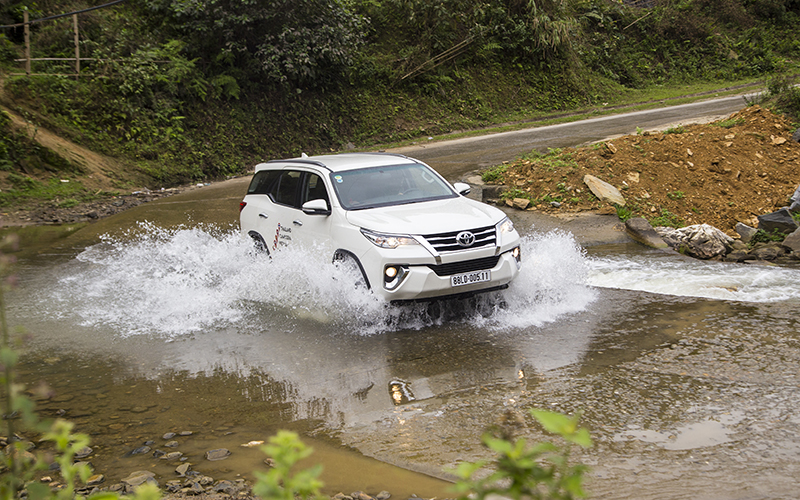 Lao Cai, Vietnam - Mar 17, 2017: Toyota Fortuner 2017 SUV in a test drive for ability on multi terrains in mountain are, Vietnam.