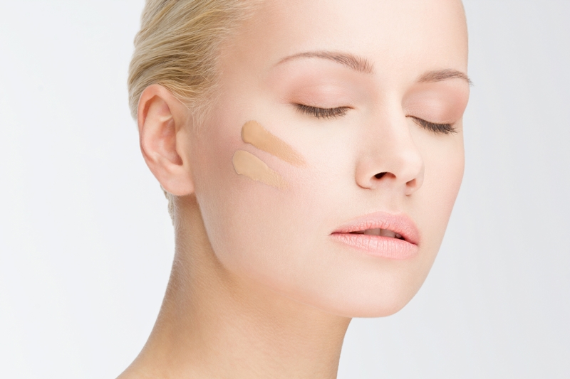 close-up portrait of young beautiful woman with cosmetic foundation