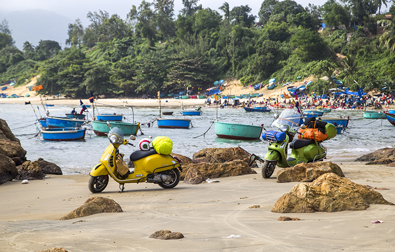 Binh Dinh, Viet Nam - Nov 10, 2017: Vespa GTS motorbike is on the beach road in the roadtrip and test drive in Vietnam.